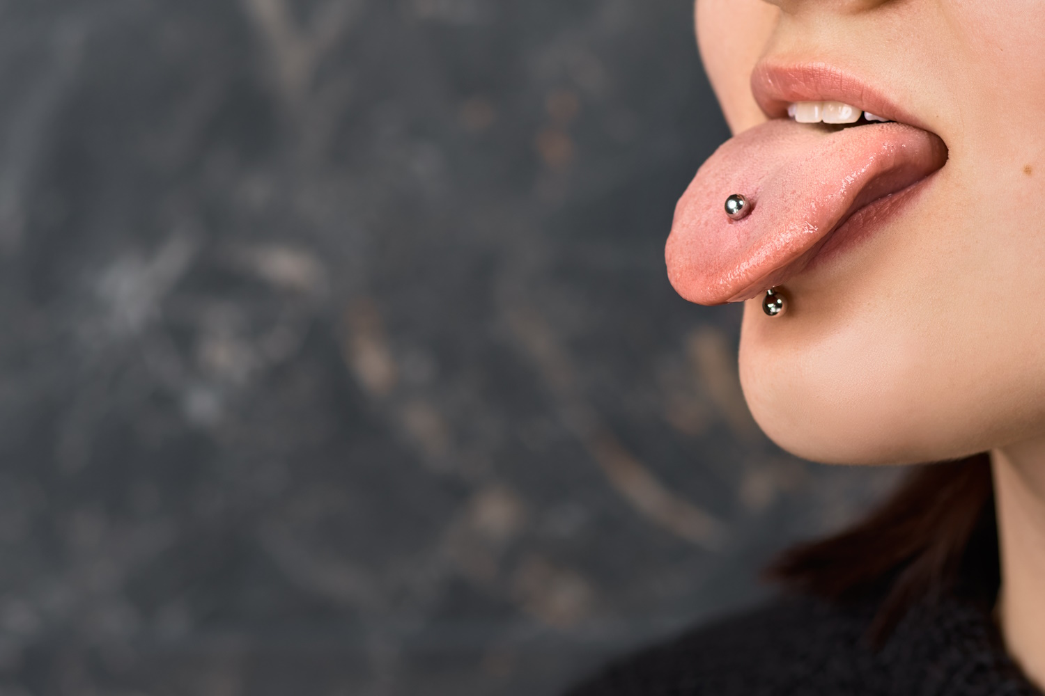 A tongue piercing with a barbell in it.