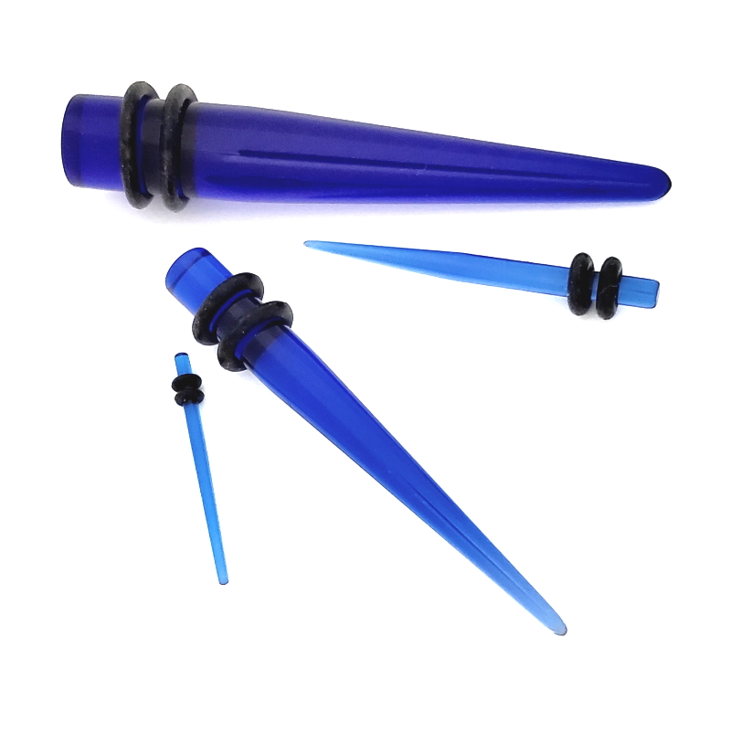 Random sizes of blue acrylic tapers pictured against a white background.