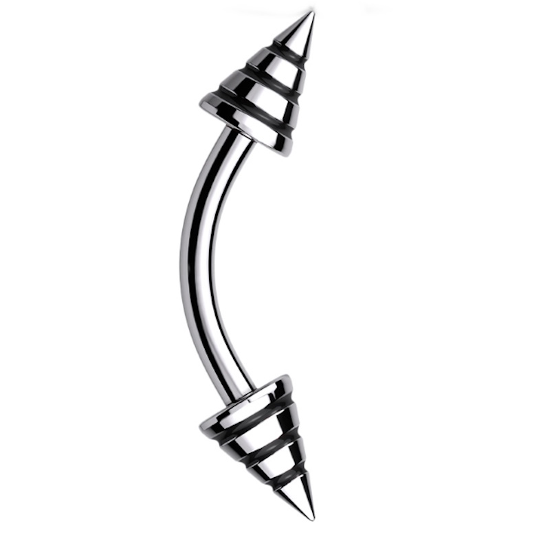 One of the types of body jewelry known as a curved barbell that features black stripes around the spike ends of this eyebrow bar.