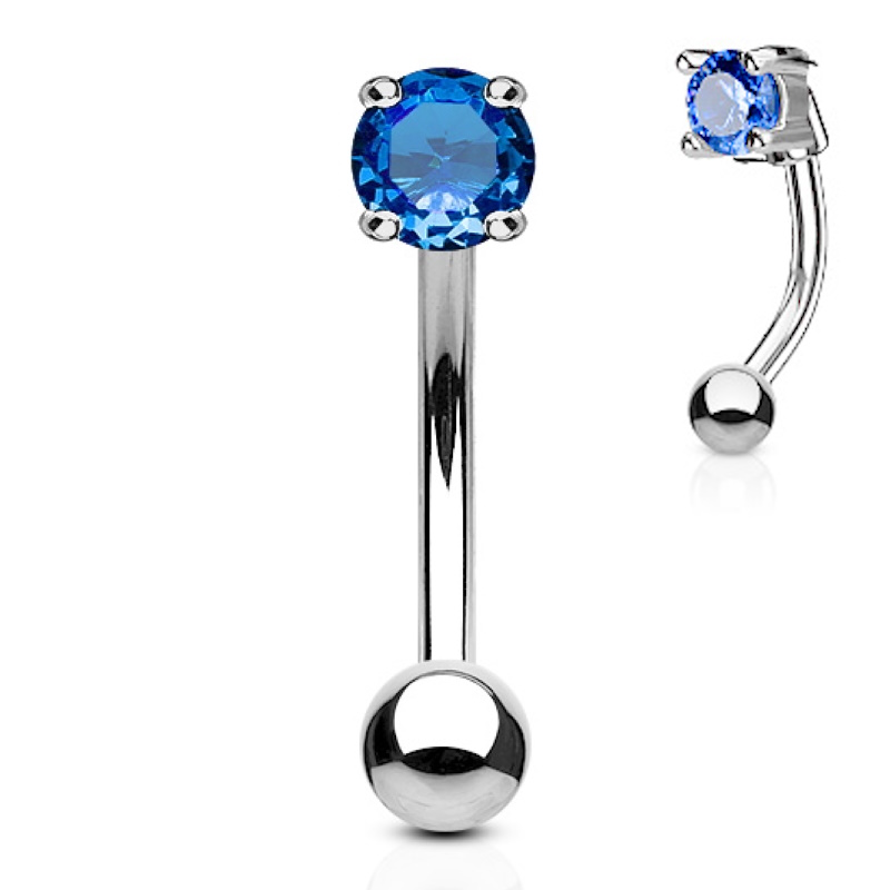 A blue gem curved barbell  type of body jewelry made for eyebrow piercings.