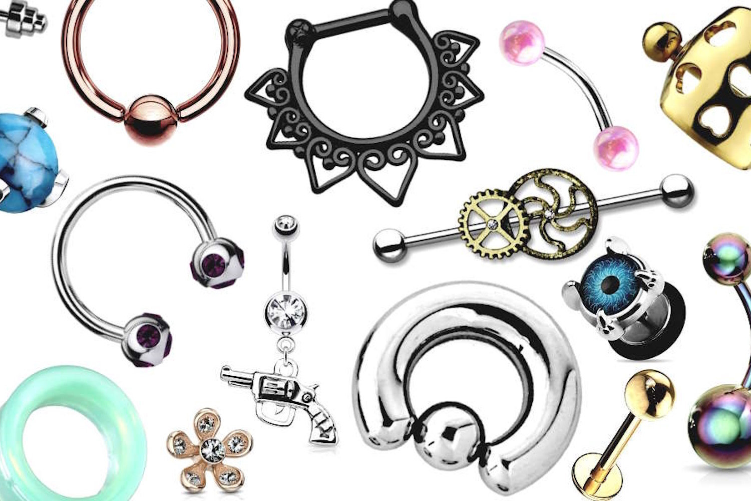 Several designs of body jewelry placed randomly on a white background.