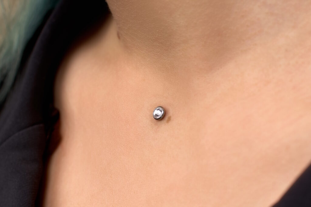The neck of a woman with a dermal in the center.