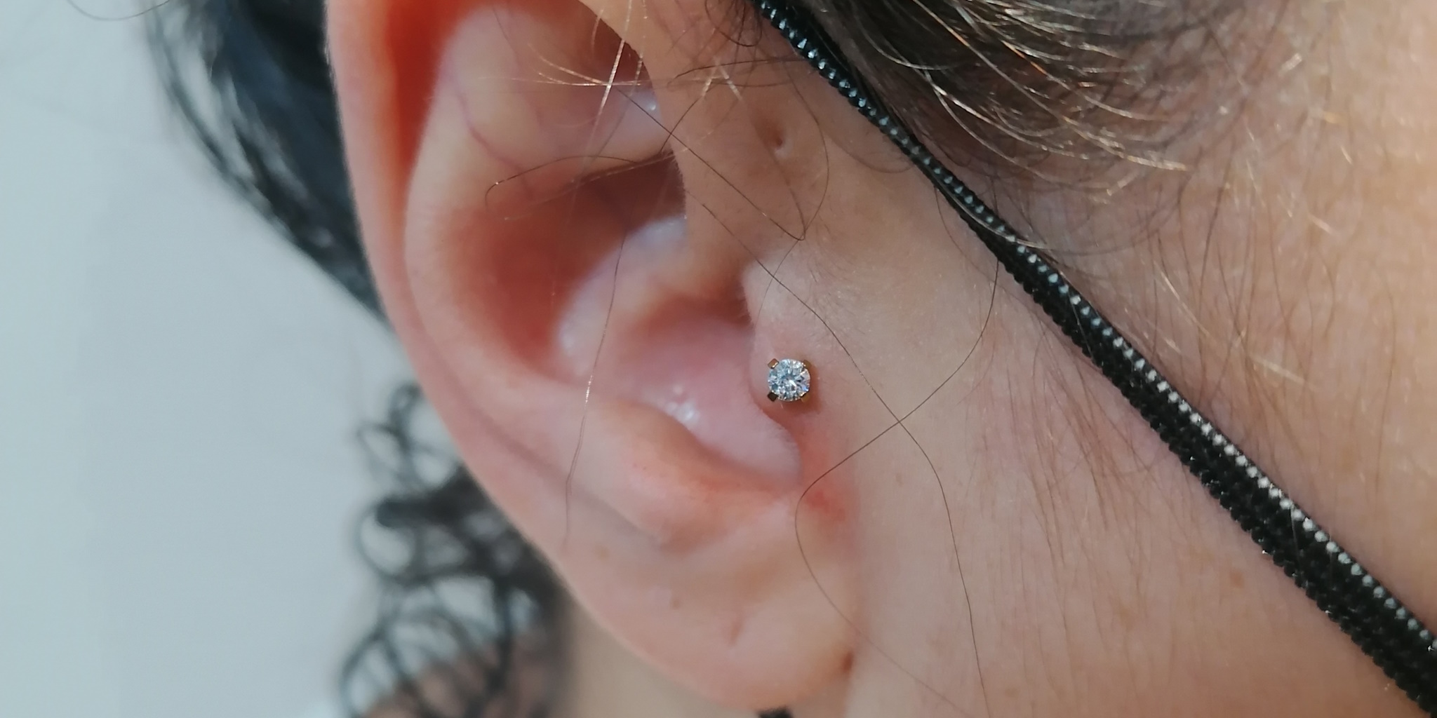 A woman with a tragus piercing.