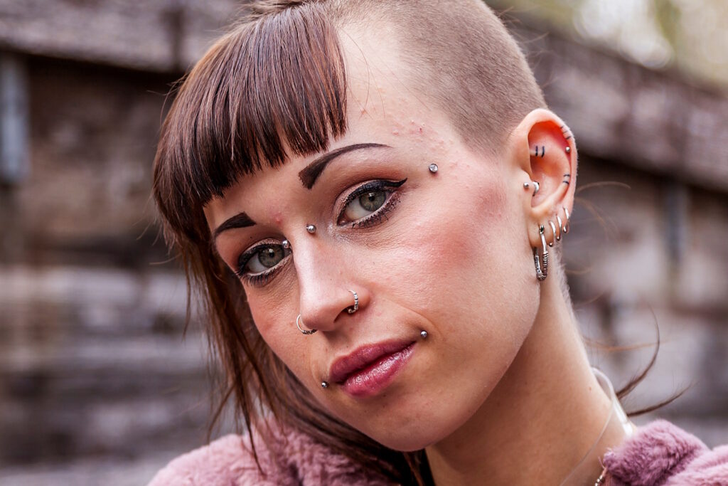 A punk woman with several piercings.
