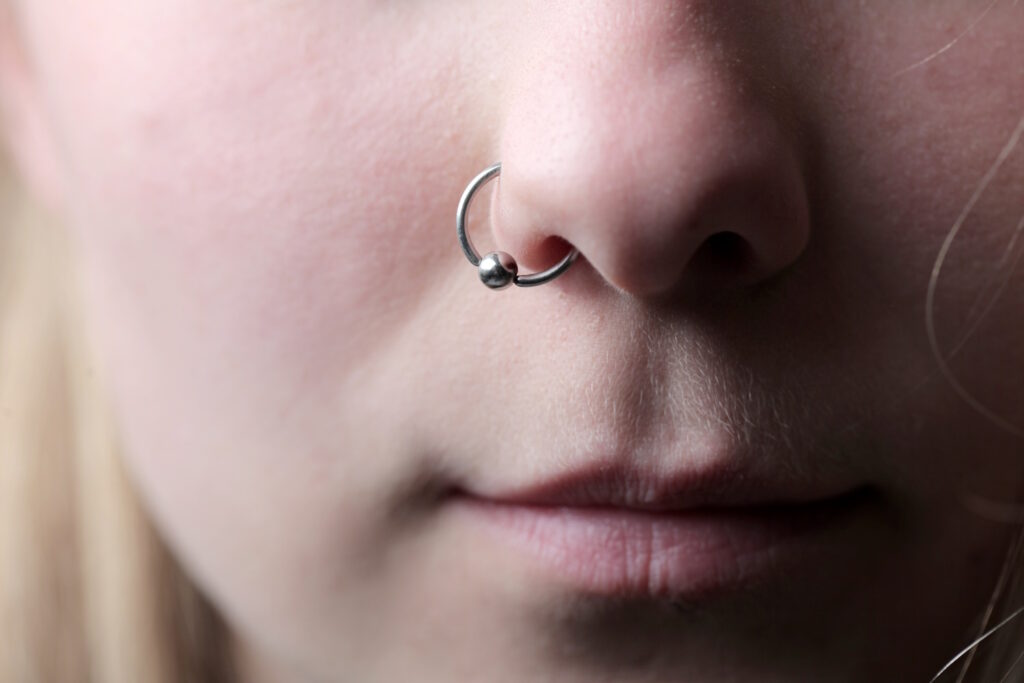 A woman with a captive bead ring in her nostril piercing.