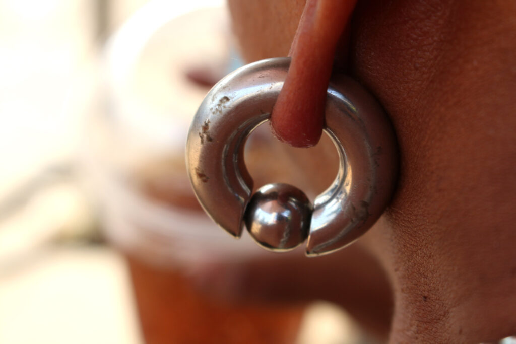 A stretched piercing with a large gauge captive bead ring in it.
